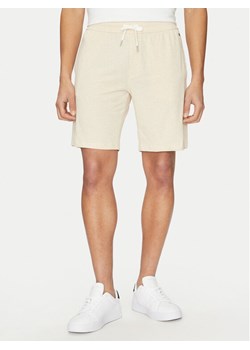 Tommy Hilfiger Szorty sportowe UM0UM03364 Beżowy Regular Fit ze sklepu MODIVO w kategorii Spodenki męskie - zdjęcie 181046414