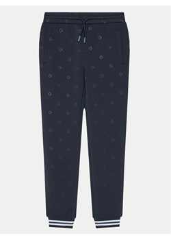 Guess Spodnie dresowe L5RQ12 KAZQ2 Granatowy Regular Fit ze sklepu MODIVO w kategorii Spodnie chłopięce - zdjęcie 181050770