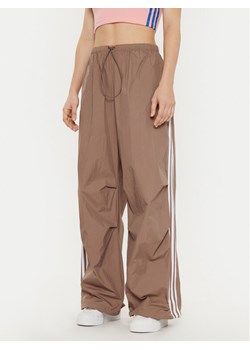 adidas Spodnie dresowe 3-Stripes JD3126 Beżowy Loose Fit ze sklepu MODIVO w kategorii Spodnie damskie - zdjęcie 181056470