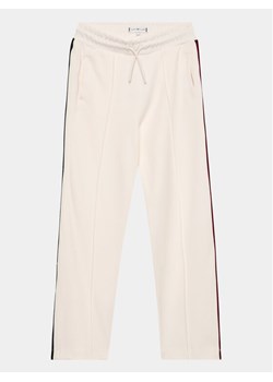 Tommy Hilfiger Spodnie dresowe KG0KG07407 D Écru Regular Fit ze sklepu MODIVO w kategorii Spodnie dziewczęce - zdjęcie 181079721
