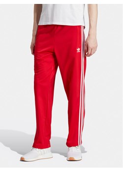 adidas Spodnie dresowe adicolor Classics Firebird IJ7057 Czerwony Regular Fit ze sklepu MODIVO w kategorii Spodnie męskie - zdjęcie 181086411