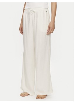 Tommy Hilfiger Spodnie piżamowe UW0UW05230 Écru Relaxed Fit ze sklepu MODIVO w kategorii Piżamy damskie - zdjęcie 181089174