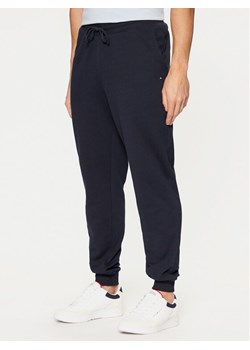 Tommy Hilfiger Spodnie dresowe Terry MW0MW37236 Granatowy Regular Fit ze sklepu MODIVO w kategorii Spodnie męskie - zdjęcie 181106764