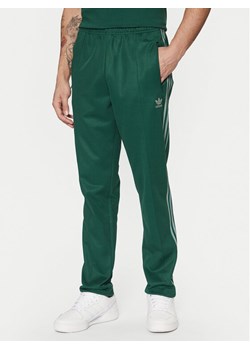 adidas Spodnie dresowe adicolor Classics Beckenbauer JP2523 Zielony Slim Fit ze sklepu MODIVO w kategorii Spodnie męskie - zdjęcie 181110100