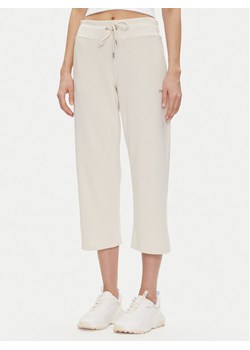 DKNY Sport Spodnie dresowe DP5P3624 Beżowy Regular Fit ze sklepu MODIVO w kategorii Spodnie damskie - zdjęcie 181112992