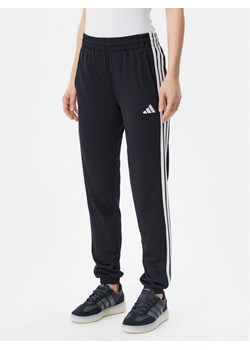 adidas Spodnie dresowe Tricot 3-Stripes JF3383 Czarny Regular Fit ze sklepu MODIVO w kategorii Spodnie damskie - zdjęcie 181123901
