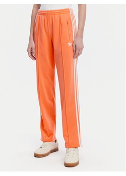 adidas Spodnie dresowe adicolor Classics Firebird JC8286 Pomarańczowy Regular Fit ze sklepu MODIVO w kategorii Spodnie damskie - zdjęcie 181133934