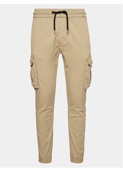 Alpha Industries Joggery Twill 116202 Beżowy Regular Fit ze sklepu MODIVO w kategorii Spodnie męskie - zdjęcie 181149644