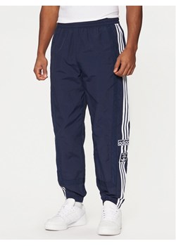 adidas Spodnie dresowe Adibreak JD4258 Granatowy Loose Fit ze sklepu MODIVO w kategorii Spodnie męskie - zdjęcie 181150814
