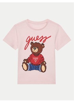 Guess T-Shirt H4BT01 I3Z14 Różowy Regular Fit ze sklepu MODIVO w kategorii Bluzki dziewczęce - zdjęcie 181174632