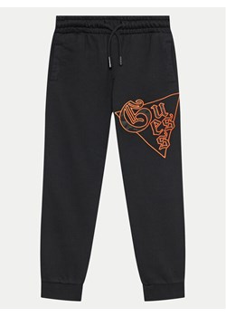 Guess Spodnie dresowe L4BQ11 KAD74 Czarny Regular Fit ze sklepu MODIVO w kategorii Spodnie chłopięce - zdjęcie 181191482