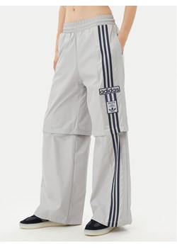 adidas Spodnie dresowe Adibreak JJ3122 Szary Regular Fit ze sklepu MODIVO w kategorii Spodnie damskie - zdjęcie 181887340