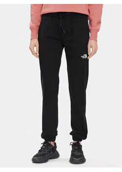 The North Face Spodnie dresowe Standard NF0A5ID4 Czarny Regular Fit ze sklepu MODIVO w kategorii Spodnie damskie - zdjęcie 181887931