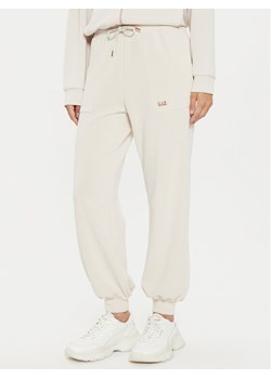 EA7 Emporio Armani Spodnie dresowe 6DTP61 TJZBZ 1120 Beżowy Regular Fit ze sklepu MODIVO w kategorii Spodnie damskie - zdjęcie 182601761