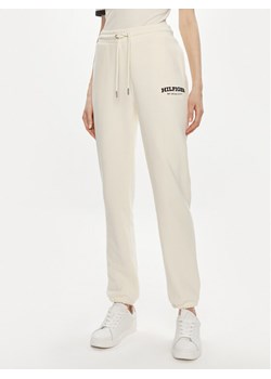 Tommy Hilfiger Spodnie dresowe Monotype WW0WW41572 Beżowy Regular Fit ze sklepu MODIVO w kategorii Spodnie damskie - zdjęcie 182601773