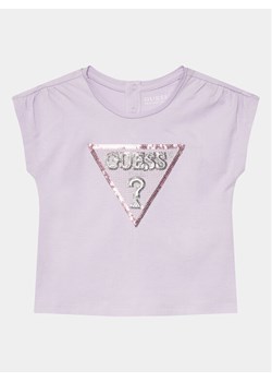 Guess T-Shirt K4GI11 K6YW4 Fioletowy Regular Fit ze sklepu MODIVO w kategorii Bluzki dziewczęce - zdjęcie 182604243
