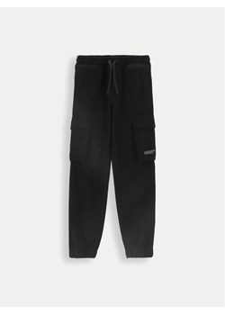 Coccodrillo Spodnie materiałowe ZC4119101DBJ Czarny Slim Fit ze sklepu MODIVO w kategorii Spodnie dziewczęce - zdjęcie 182608744