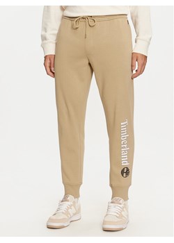 Timberland Spodnie dresowe TB0A5YFBDH41 Beżowy Regular Fit ze sklepu MODIVO w kategorii Spodnie męskie - zdjęcie 182623250