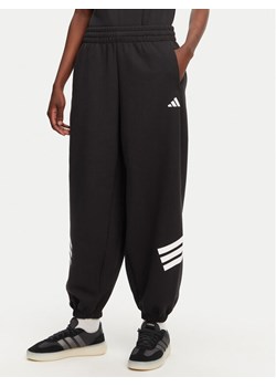 adidas Spodnie dresowe Future Icons 3-Stripes Parachute JE0141 Czarny Loose Fit ze sklepu MODIVO w kategorii Spodnie damskie - zdjęcie 182624111