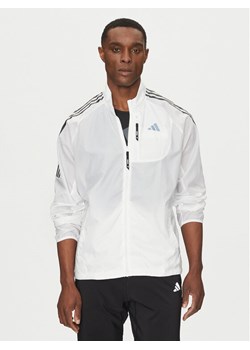 adidas Kurtka do biegania Own the Run 3-Stripes JD7760 Biały Slim Fit ze sklepu MODIVO w kategorii Kurtki męskie - zdjęcie 182630331