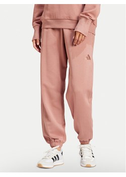 adidas Spodnie dresowe ALL SZN French Terry JD4721 Różowy Loose Fit ze sklepu MODIVO w kategorii Spodnie damskie - zdjęcie 182631721