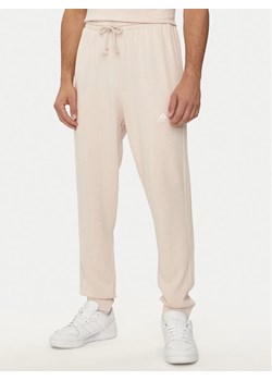 adidas Spodnie dresowe ALL SZN 3-Stripes IR5201 Różowy Regular Fit ze sklepu MODIVO w kategorii Spodnie męskie - zdjęcie 182637634