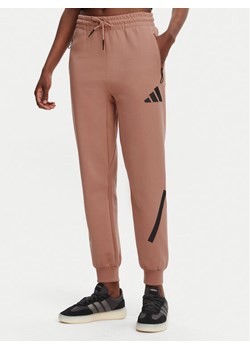 adidas Spodnie dresowe Z.N.E. JD5995 Różowy Regular Fit ze sklepu MODIVO w kategorii Spodnie damskie - zdjęcie 182640920