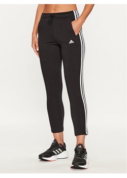 adidas Spodnie dresowe Essentials 3-Stripes IC6126 Czarny Slim Fit ze sklepu MODIVO w kategorii Spodnie dziewczęce - zdjęcie 182644282