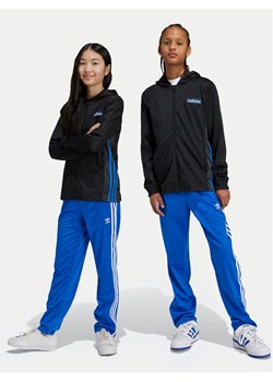 adidas Spodnie dresowe Firebird IY9803 Niebieski Regular Fit ze sklepu MODIVO w kategorii Spodnie chłopięce - zdjęcie 182648452