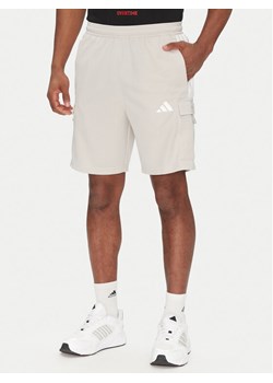 adidas Szorty sportowe Tiro Cargo JC7958 Beżowy Regular Fit ze sklepu MODIVO w kategorii Spodenki męskie - zdjęcie 182648854