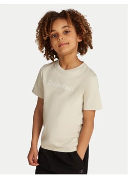 Calvin Klein Jeans T-Shirt IU0IU00682 Beżowy Regular Fit ze sklepu MODIVO w kategorii Bluzki dziewczęce - zdjęcie 182656722