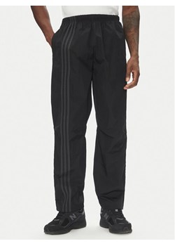 adidas Spodnie dresowe Fashion Side Mesh JD0051 Czarny Loose Fit ze sklepu MODIVO w kategorii Spodnie męskie - zdjęcie 182665161