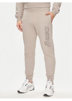 Asics Spodnie dresowe Logo 2031E189 Szary Regular Fit ze sklepu MODIVO w kategorii Spodnie męskie - zdjęcie 182671891