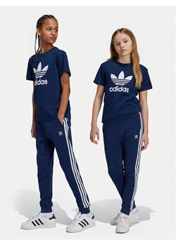 adidas Spodnie dresowe Trefoil IY7486 Granatowy Regular Fit ze sklepu MODIVO w kategorii Spodnie chłopięce - zdjęcie 182686421