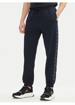EA7 Emporio Armani Spodnie dresowe 7M000216 AF12660 UB102 Granatowy Regular Fit ze sklepu MODIVO w kategorii Spodnie męskie - zdjęcie 182686522