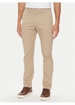 Tommy Hilfiger Chinosy Bleecker MW0MW26619 Beżowy Slim Fit ze sklepu MODIVO w kategorii Spodnie męskie - zdjęcie 182690481