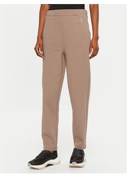 Calvin Klein Spodnie dresowe Satin K20K207945 Beżowy Slim Fit ze sklepu MODIVO w kategorii Spodnie damskie - zdjęcie 182693300