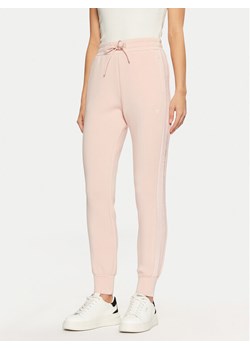 Guess Spodnie dresowe V2YB18 K7UW2 Różowy Regular Fit ze sklepu MODIVO w kategorii Spodnie damskie - zdjęcie 182698424