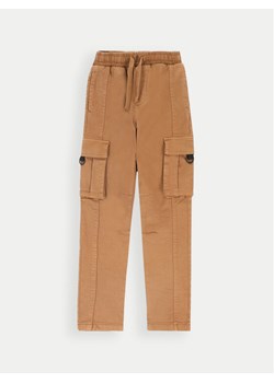 Coccodrillo Spodnie materiałowe ZC4119101FBJ Brązowy Slim Fit ze sklepu MODIVO w kategorii Spodnie dziewczęce - zdjęcie 182709110