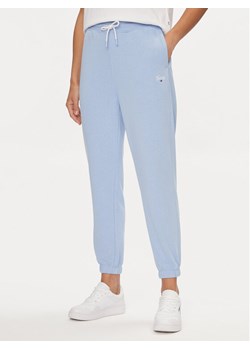 Tommy Jeans Spodnie dresowe Script DW0DW17771 Błękitny Relaxed Fit ze sklepu MODIVO w kategorii Spodnie damskie - zdjęcie 182719802