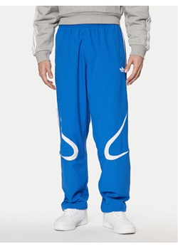 adidas Spodnie dresowe adicolor Teamgeist JP1120 Niebieski Regular Fit ze sklepu MODIVO w kategorii Spodnie męskie - zdjęcie 182721463