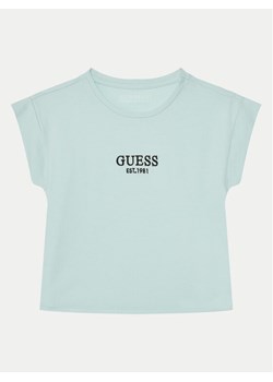 Guess T-Shirt J4BI34 J1314 Błękitny Boxy Fit ze sklepu MODIVO w kategorii Bluzki dziewczęce - zdjęcie 182727024