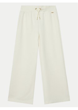Guess Spodnie dresowe J5RB15 KCHR2 Écru Relaxed Fit ze sklepu MODIVO w kategorii Spodnie dziewczęce - zdjęcie 182734962
