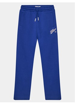Tommy Hilfiger Spodnie dresowe Hilfiger Script Wide Sweatpant KG0KG07751 Niebieski Regular Fit ze sklepu MODIVO w kategorii Spodnie chłopięce - zdjęcie 182737112