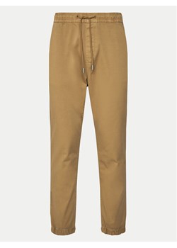 Tommy Jeans Joggery Austin DM0DM20283 Beżowy Slim Fit ze sklepu MODIVO w kategorii Spodnie męskie - zdjęcie 182737592
