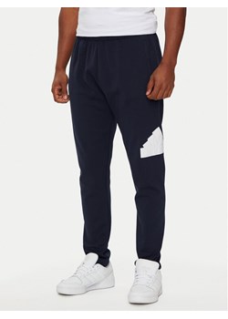 adidas Spodnie dresowe Future Icons Badge of Sport IW8584 Granatowy Regular Fit ze sklepu MODIVO w kategorii Spodnie męskie - zdjęcie 182747450