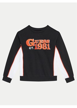Guess Bluza L4BQ02 KAX74 Czarny Regular Fit ze sklepu MODIVO w kategorii Bluzy chłopięce - zdjęcie 182754820