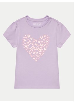 Guess T-Shirt K4GI03 K6YW4 Fioletowy Regular Fit ze sklepu MODIVO w kategorii Bluzki dziewczęce - zdjęcie 182763912