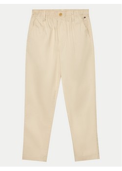Tommy Hilfiger Spodnie materiałowe Monotype KB0KB09146 Beżowy Regular Fit ze sklepu MODIVO w kategorii Spodnie dziewczęce - zdjęcie 182767793