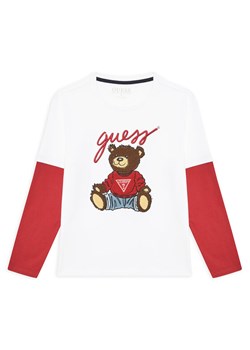 Guess Bluzka L4BI13 I3Z14 Biały Regular Fit ze sklepu MODIVO w kategorii T-shirty chłopięce - zdjęcie 183813303